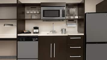A modern kitchen with a built-in microwave, dishwasher, and refrigerator.