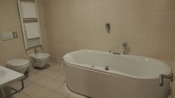 A bathroom with a bathtub, toilet, and sink.