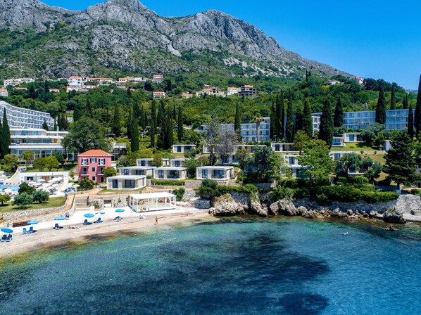 On the beach, sun-loungers, beach umbrellas, beach bar
