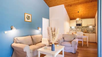 Un salon comprenant un canapé, une table basse et un coin repas avec une chaise et une table.