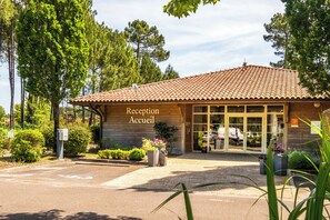 A reception building with a tiled roof and a sign that reads 'Reception Accueil'. - Résidence Pierre & Vacances Les Cottages du Lac (Parentis-en-Born)