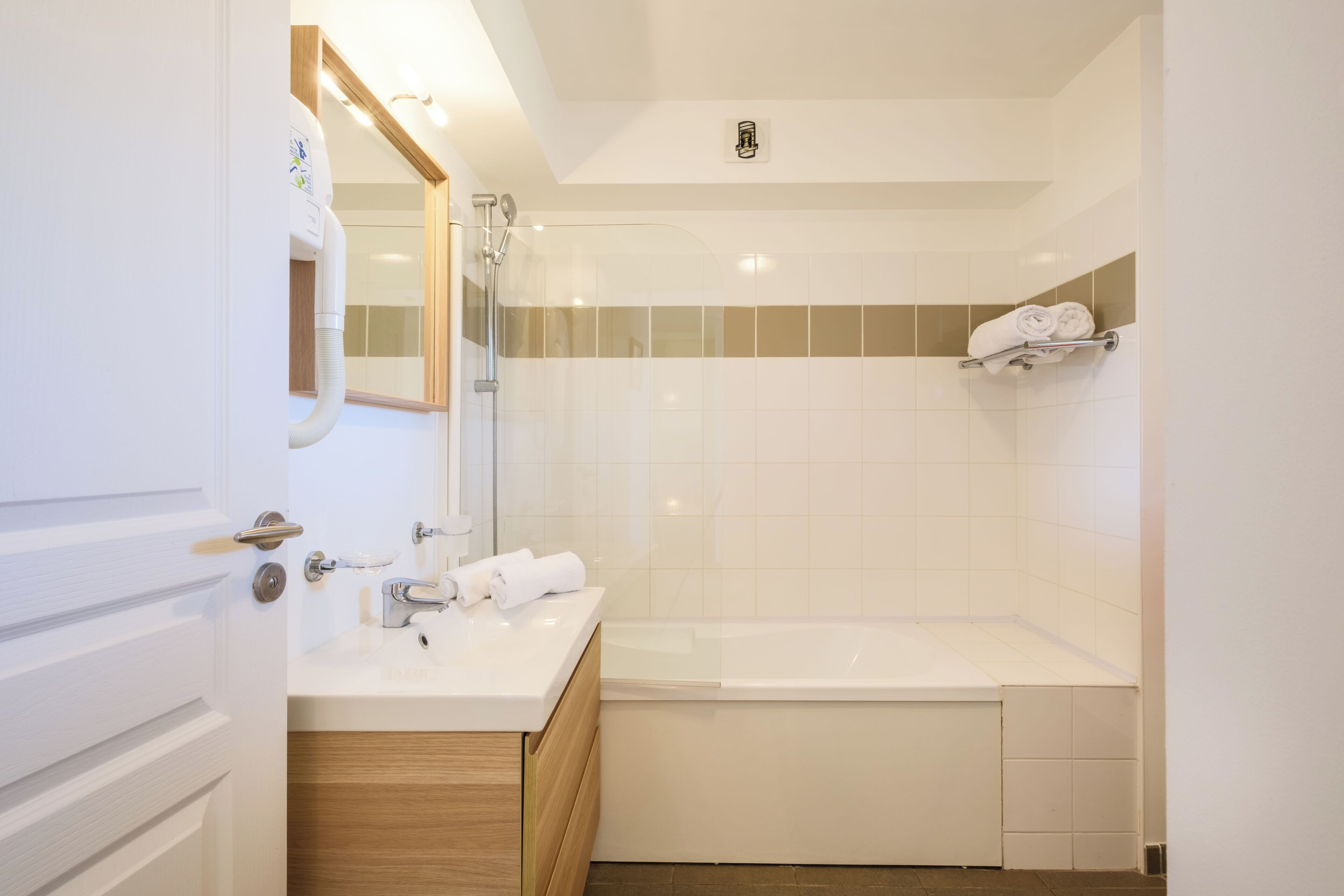 Een moderne badkamer met een bad, een wastafel en een spiegel.