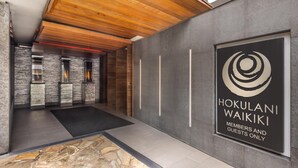 A modern interior with a sign for 'Hokulani Waikiki' indicating it's a members and guests only area.