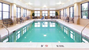 A large indoor swimming pool with a 5ft depth limit and no diving sign.