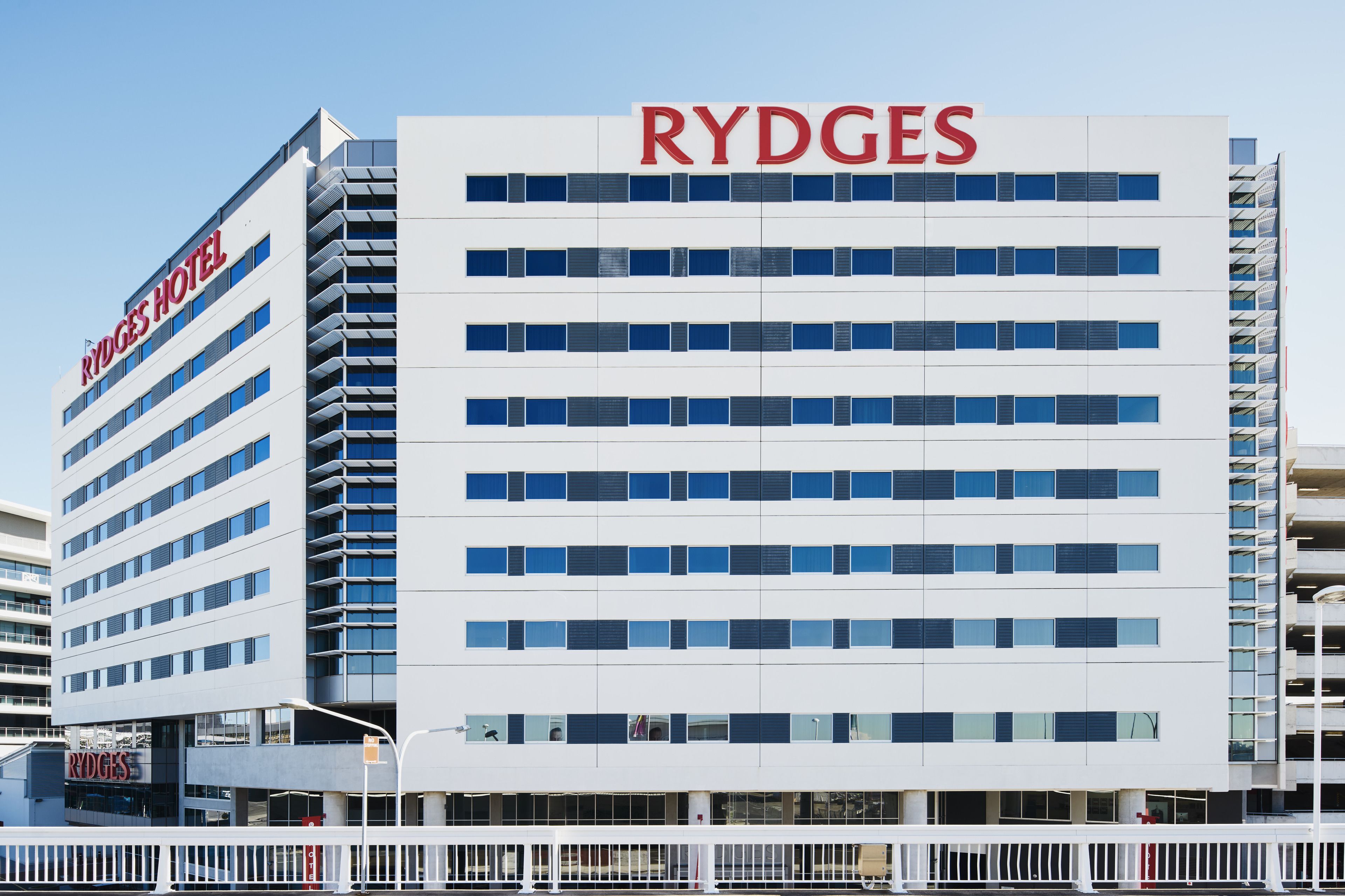 A modern hotel building with the name 'RYDGES' prominently displayed.