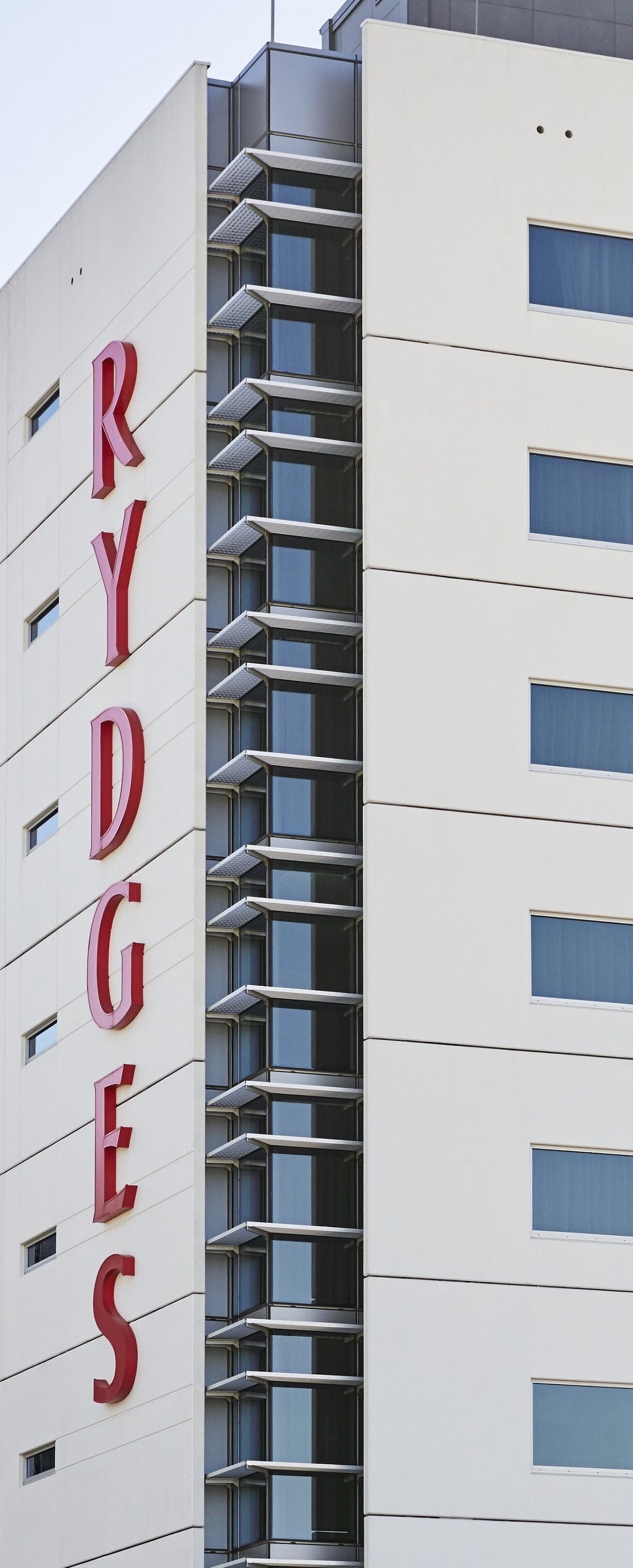 A modern building with a prominent 'RYDGES' sign on the facade.