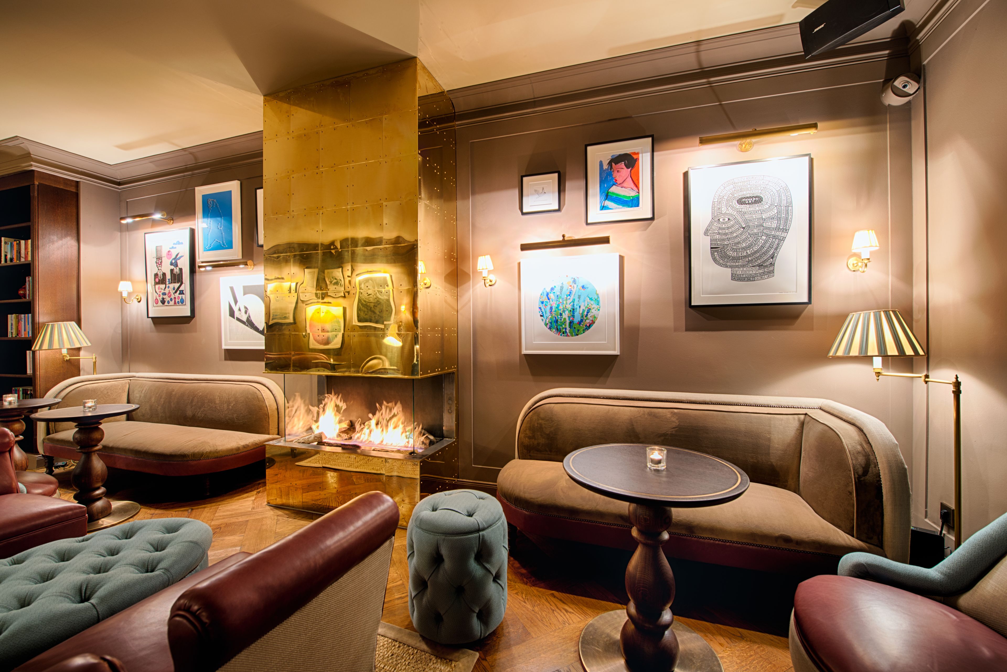A cozy lounge area with sofas, a small table, and a fireplace.