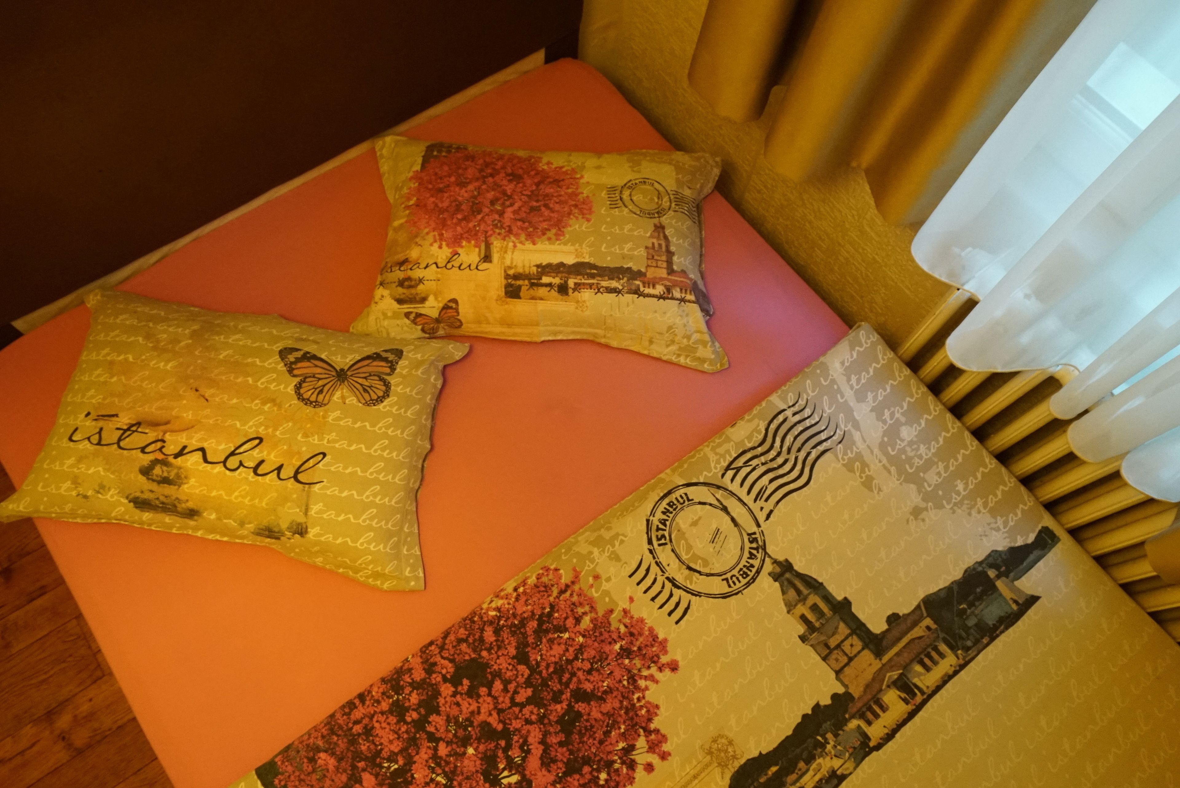 Three decorative pillows with Istanbul-themed designs on a table.