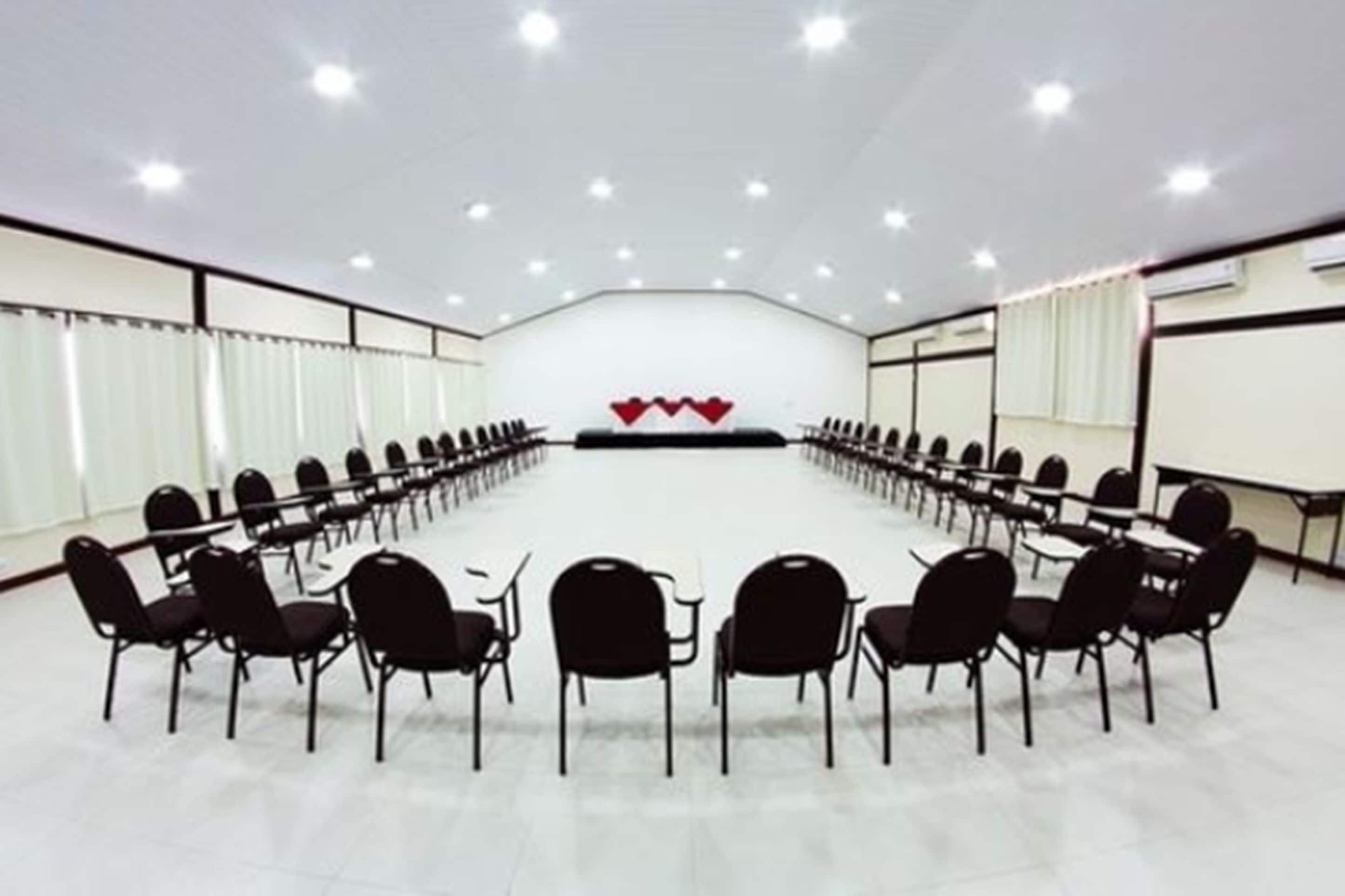 A conference room with a long table and chairs arranged for a meeting.