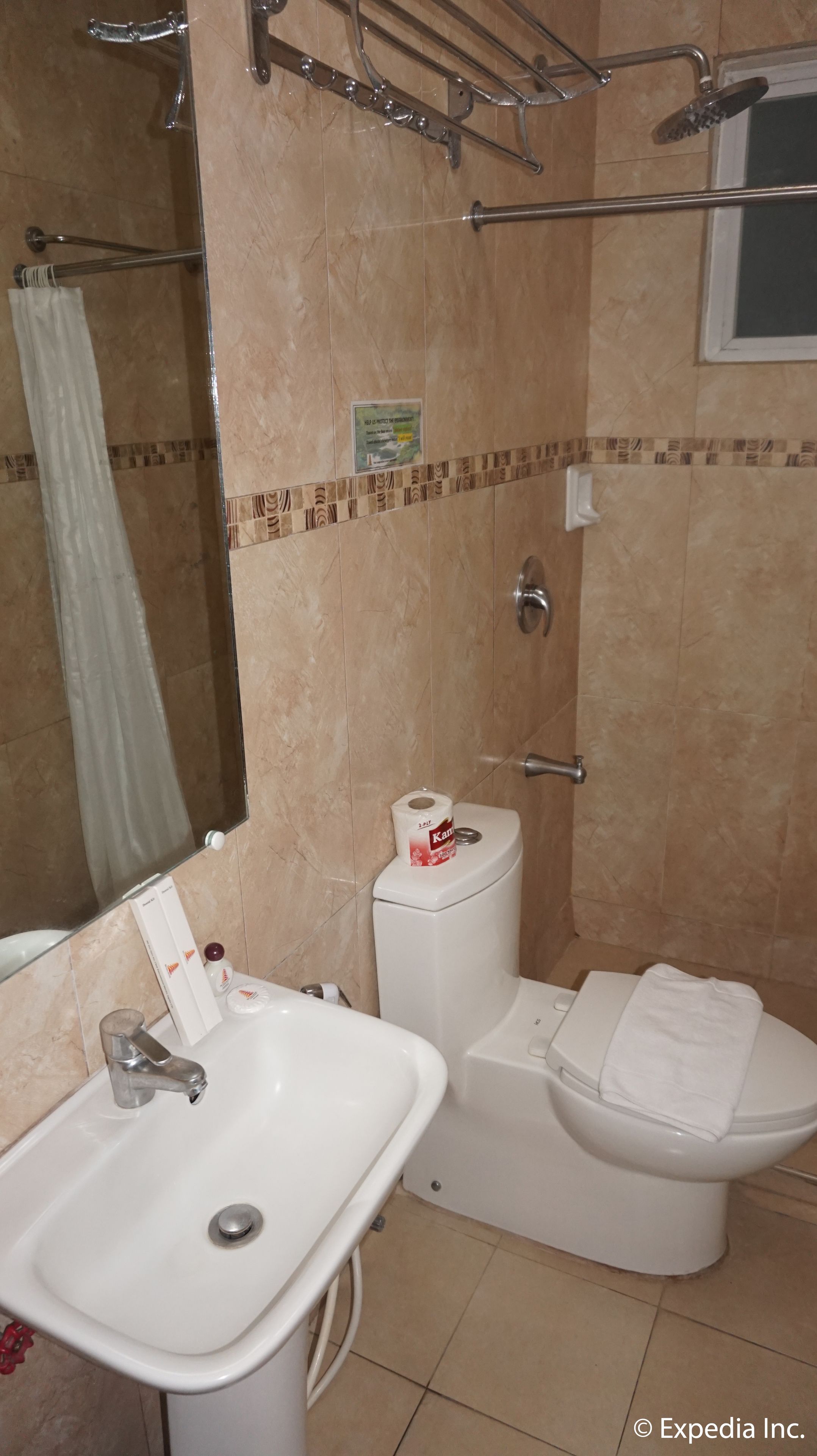 A bathroom with a sink, toilet, and shower.