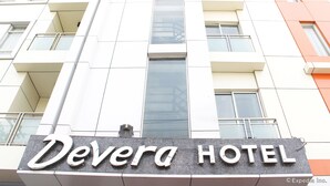 The exterior of Devera Hotel with a prominent sign, multiple balconies, and a modern architectural design. - Devera Hotel (Angeles City)