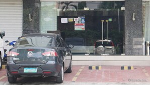 A hotel named Devera Hotel with a modern facade, a car parked in front, and a visible sign for the 5th Avenue. - Devera Hotel (Angeles City)