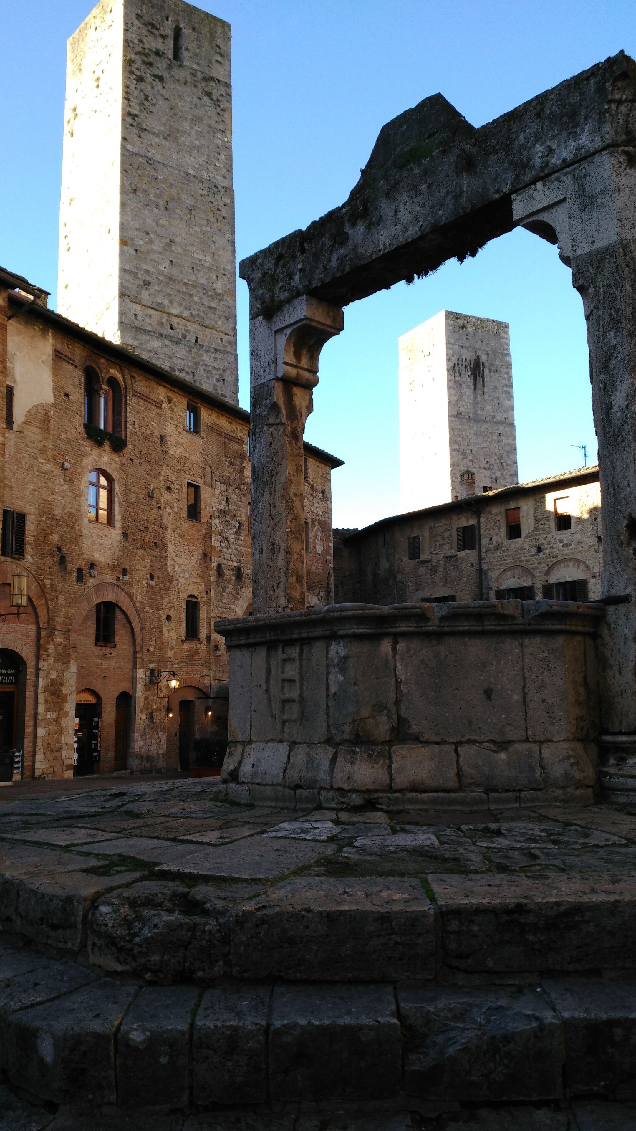An ancient stone structure with arched doorways and a large stone archway.