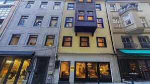 A multi-story building with a ground-floor retail space and upper residential units.