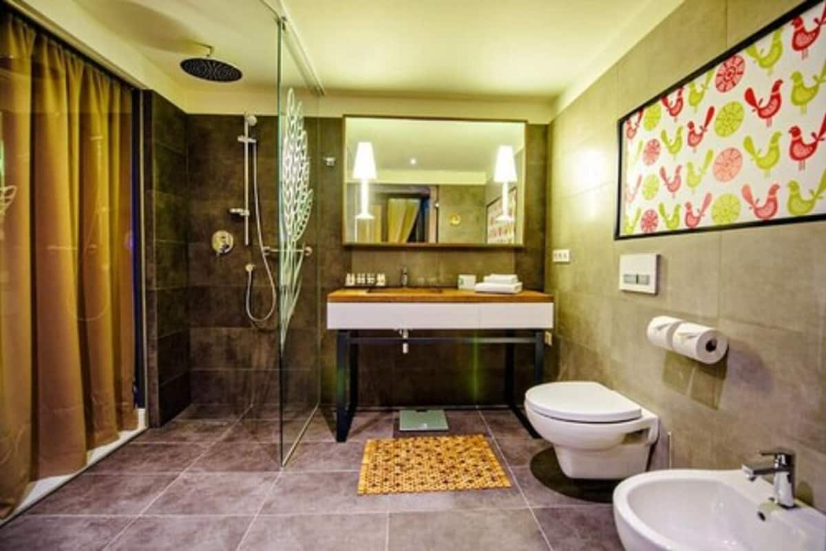 junior suite | bathroom | rainfall showerhead, designer toiletries, hair dryer, bathrobes