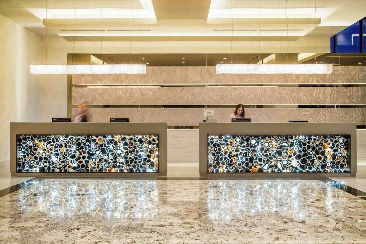 A reception area with two counters, a marble floor, and a patterned wall.