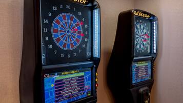 Two BullShooter dartboards with digital score displays and a main menu for game selection.