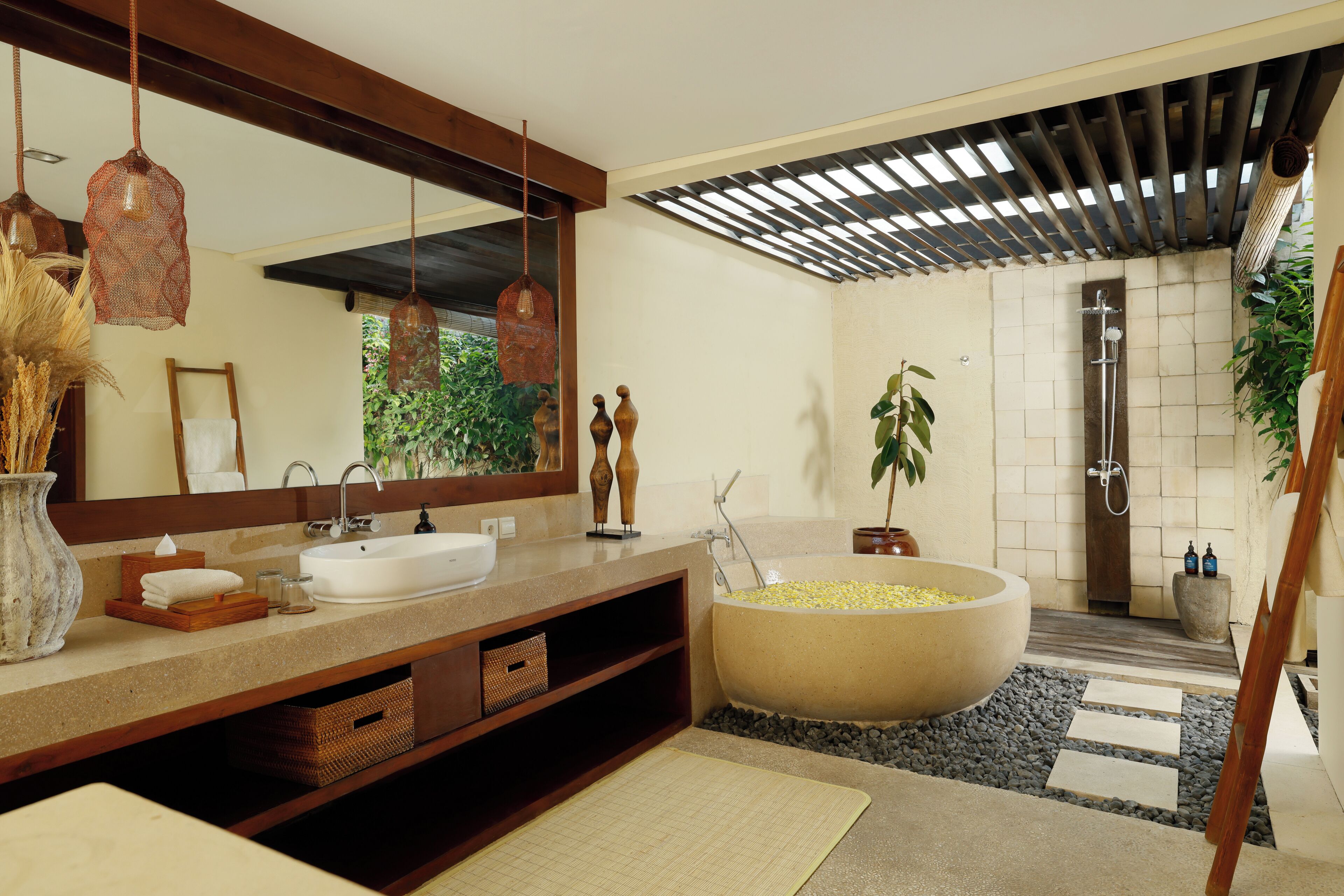 A modern bathroom with a large sink, mirror, and bathtub.