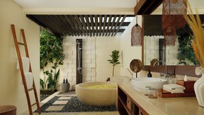 A modern bathroom with a freestanding bathtub, a large mirror, and a wooden ladder.