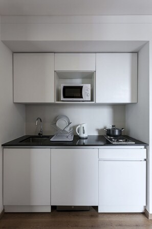 Microwave, stovetop, coffee/tea maker, cookware/dishes/utensils