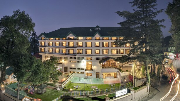 A multi-story hotel with a tennis court and a children's play area. - Club Mahindra Mashobra (Shimla)