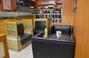 A seating area with booths and tables, featuring a Christmas garland and a menu on the table.