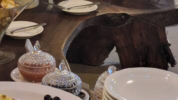 A buffet table with various dishes, including a cake, fruit, and a drink.