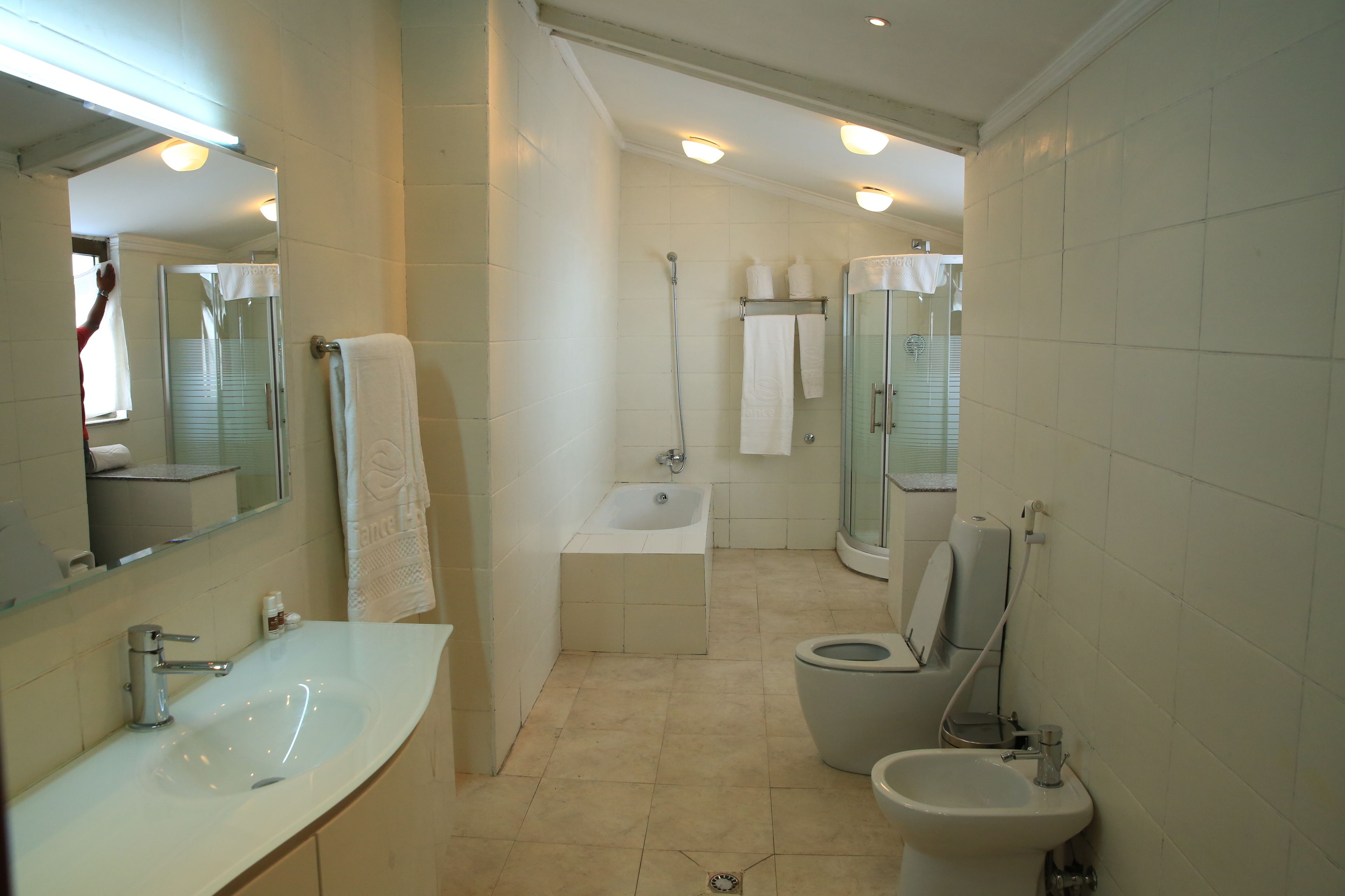 rainfall showerhead, hair dryer, slippers, towels