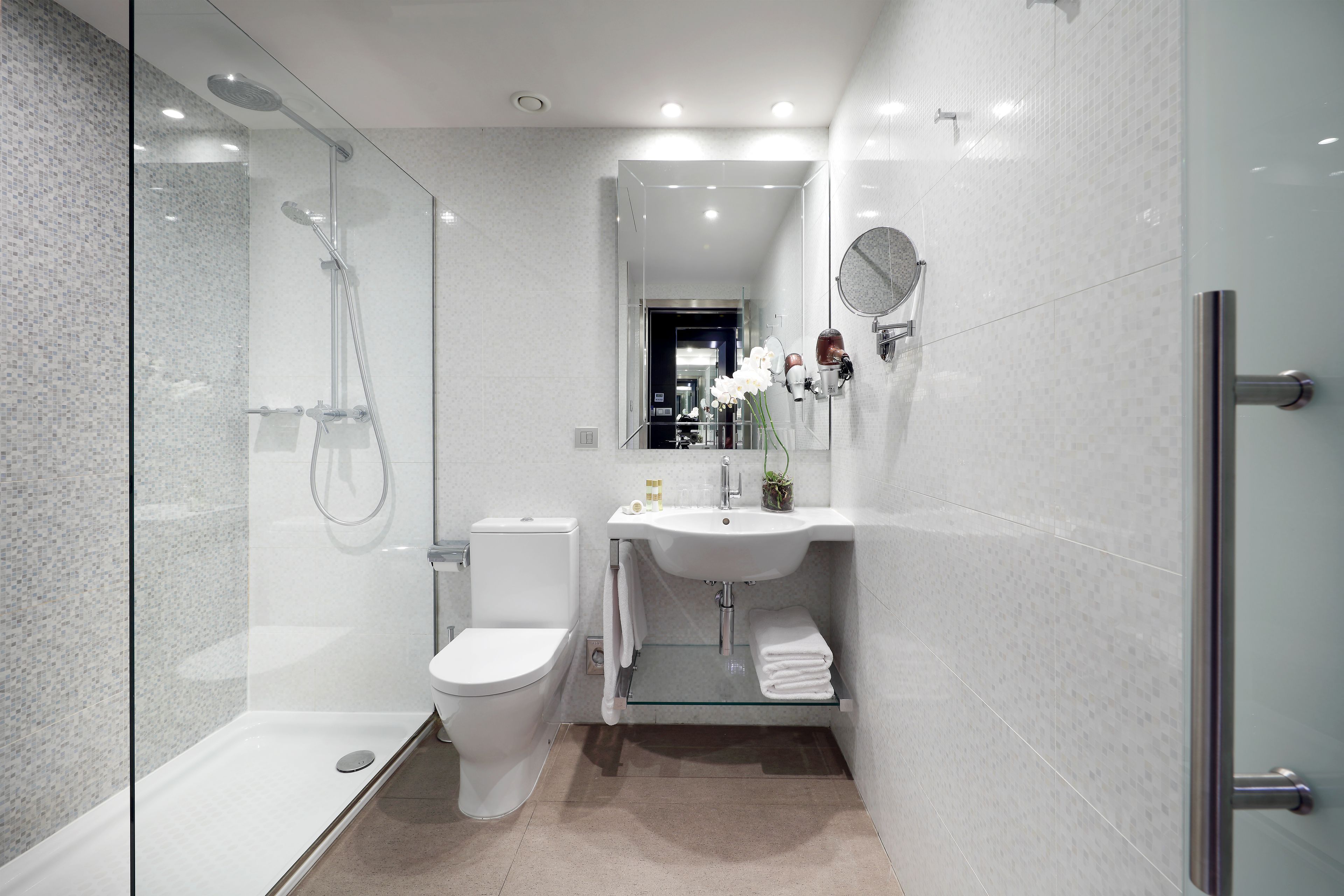 designer toiletries, hair dryer, towels