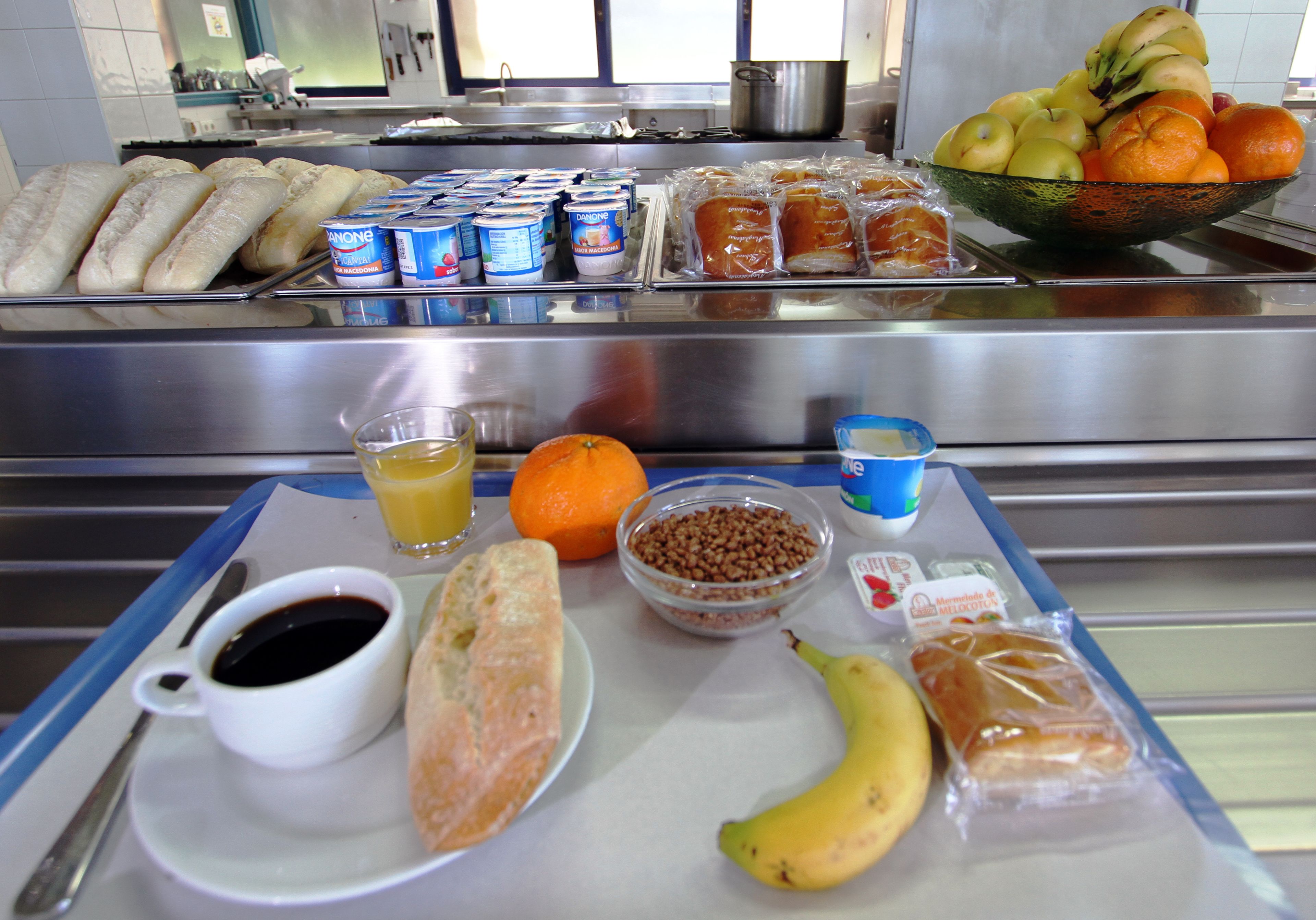 Un bufé de desayuno con pan, frutas y bebidas.