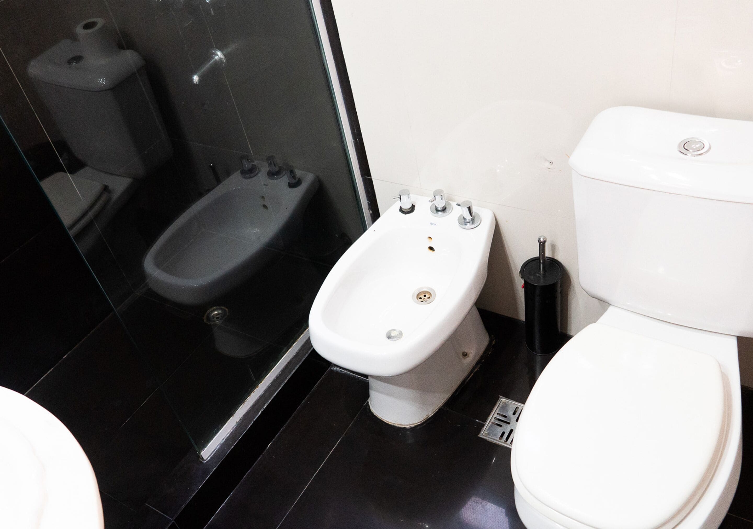 Ein Badezimmer mit Toilette, Bidet und Bidet-Sitz.