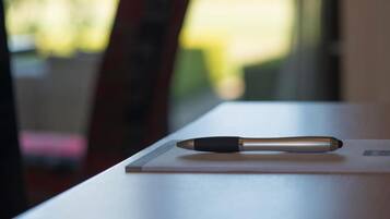 A pen on a white surface with a blurred background.