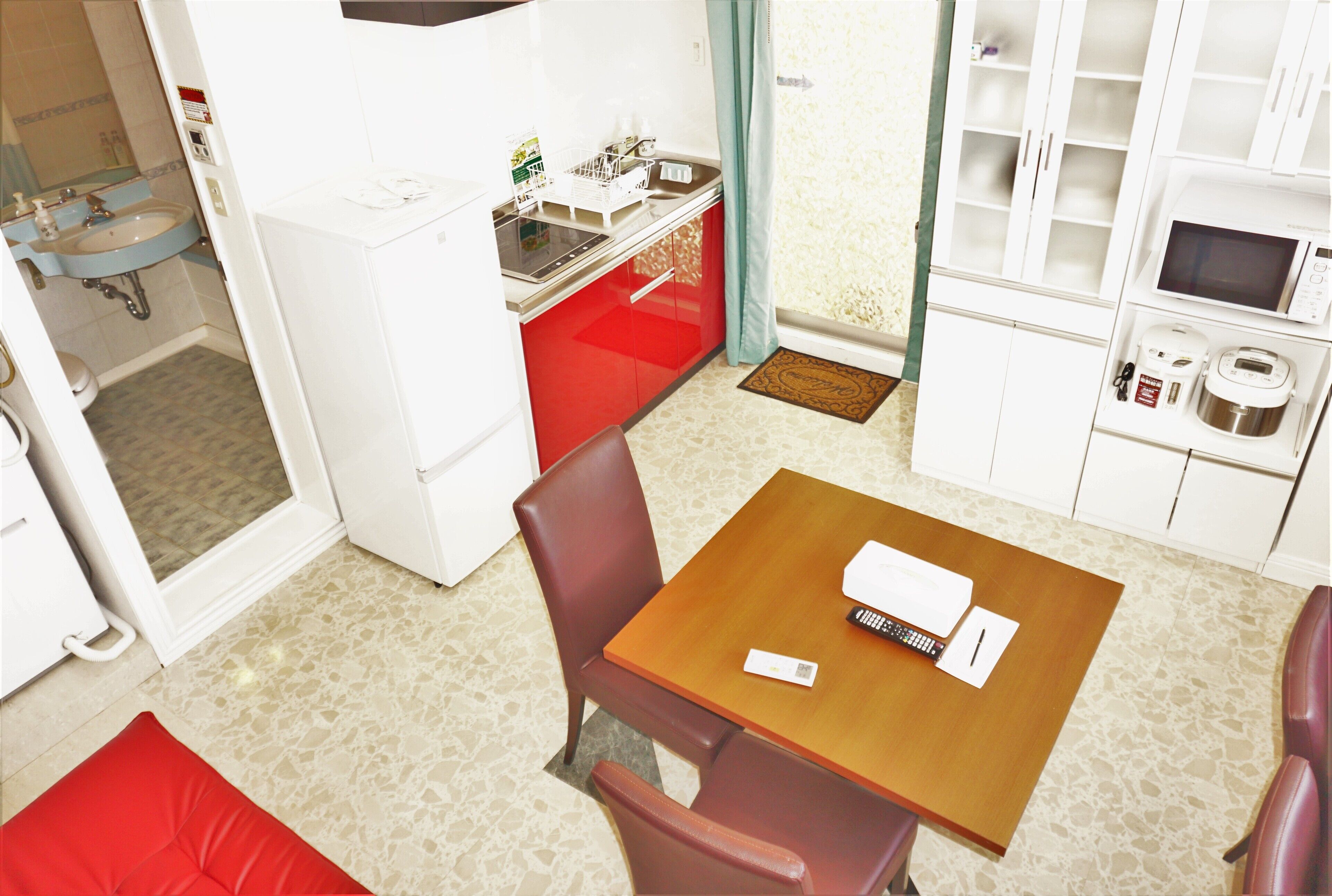 A compact kitchen with a sink, microwave, and storage cabinets.