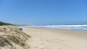 A beach with a dune and a tent. - Sunshine Coast Airport Motel (Marcoola)