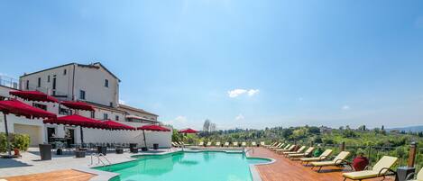 Seasonal outdoor pool, open 11:00 AM to 7:00 PM, pool umbrellas