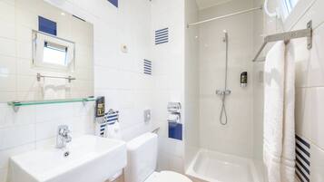 A bathroom with a sink, toilet, and bathtub.