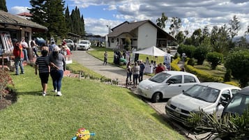 A parking area with several cars and a small child’s toy car.