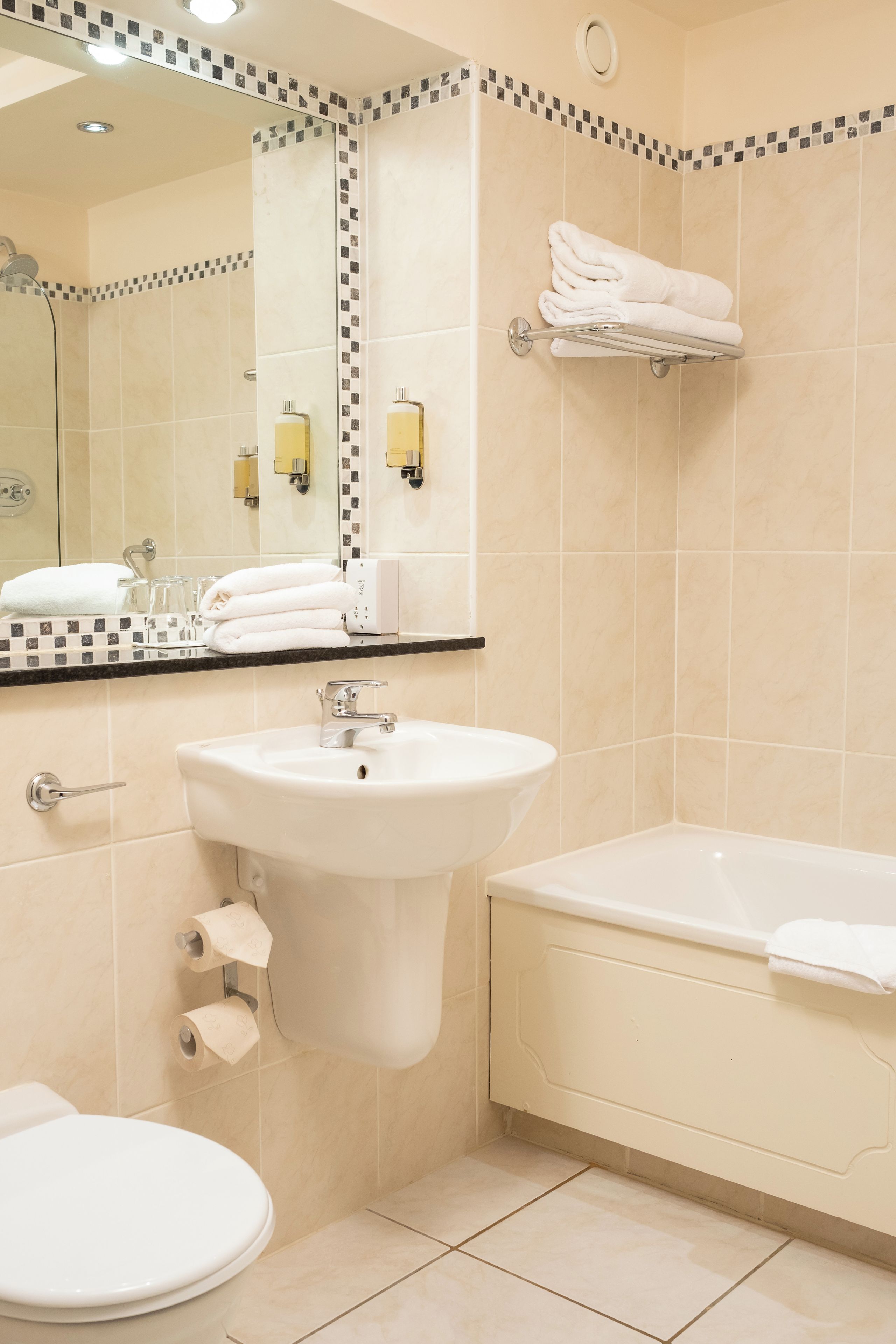A bathroom with a sink, toilet, and bathtub.