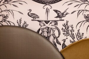 A close-up of a wallpaper with a detailed black and white illustration of birds and foliage.