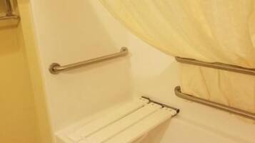 A bathroom with a bathtub, a towel rack, and a shower curtain.