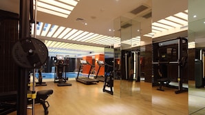 A gym with cardio machines, weightlifting equipment, and a mirrored wall. - Victory Hotel & Spa Istanbul (Istanbul)