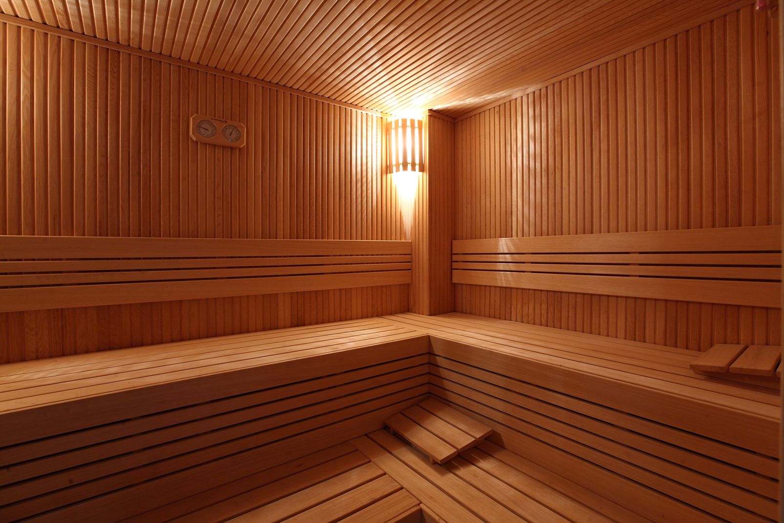 A sauna with wooden benches and slatted walls.
