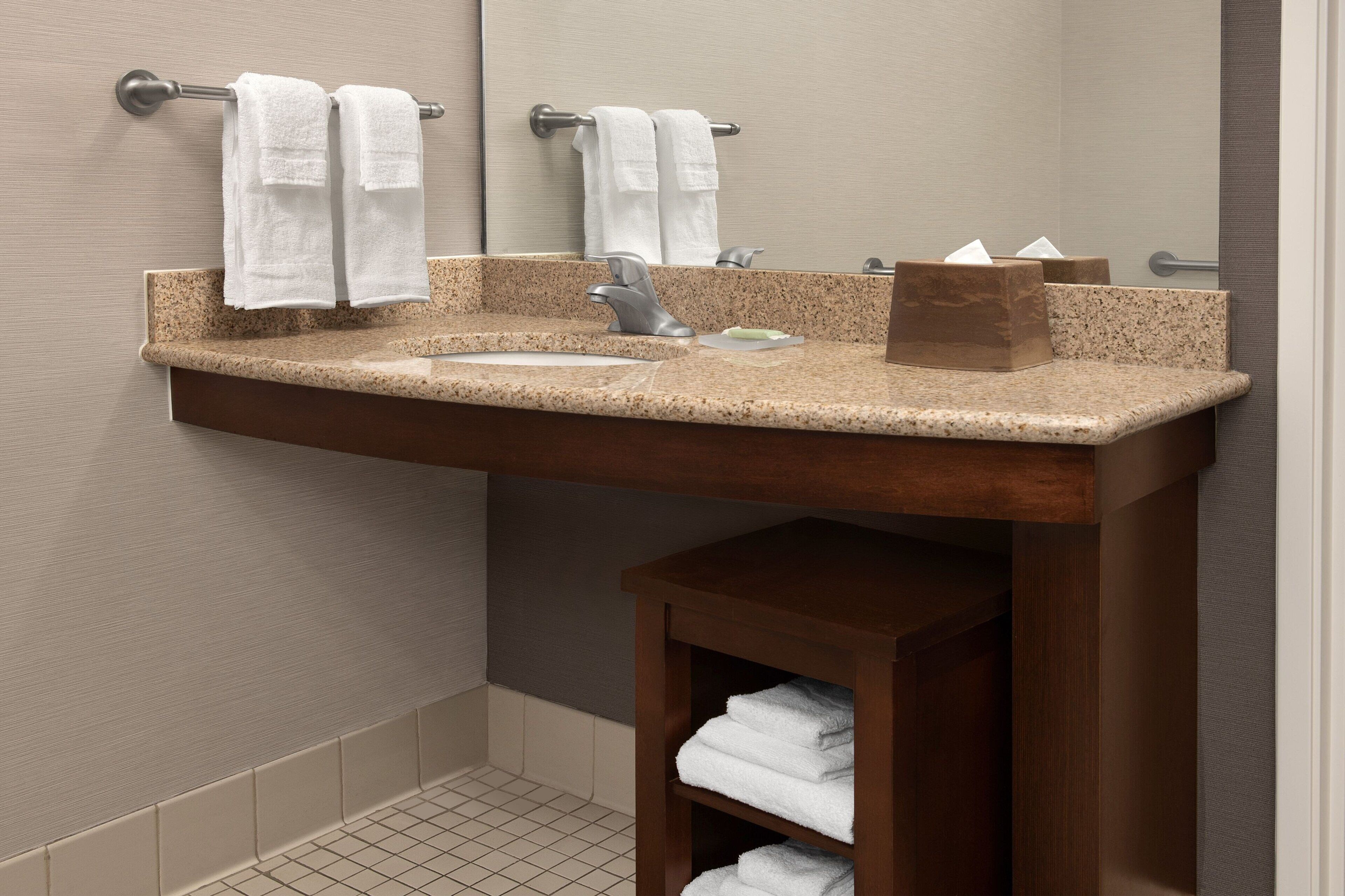 combined shower/bathtub, designer toiletries, hair dryer, towels