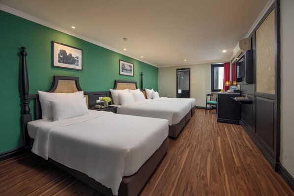 A hotel room with two beds, a desk, and a television. - Hanoi Ancient Paradise Hotel (Hanoi)