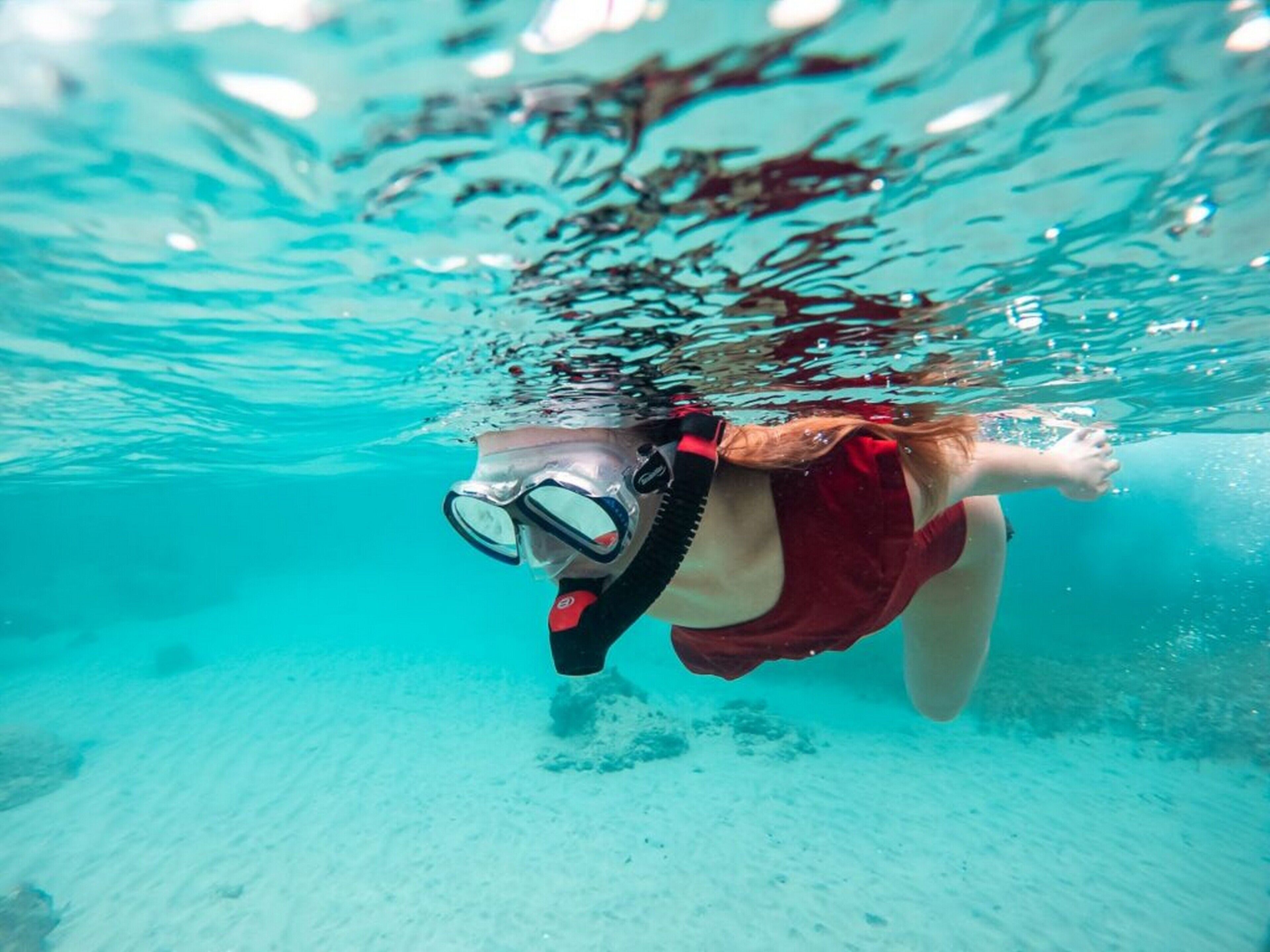 A person snorkeling underwater.