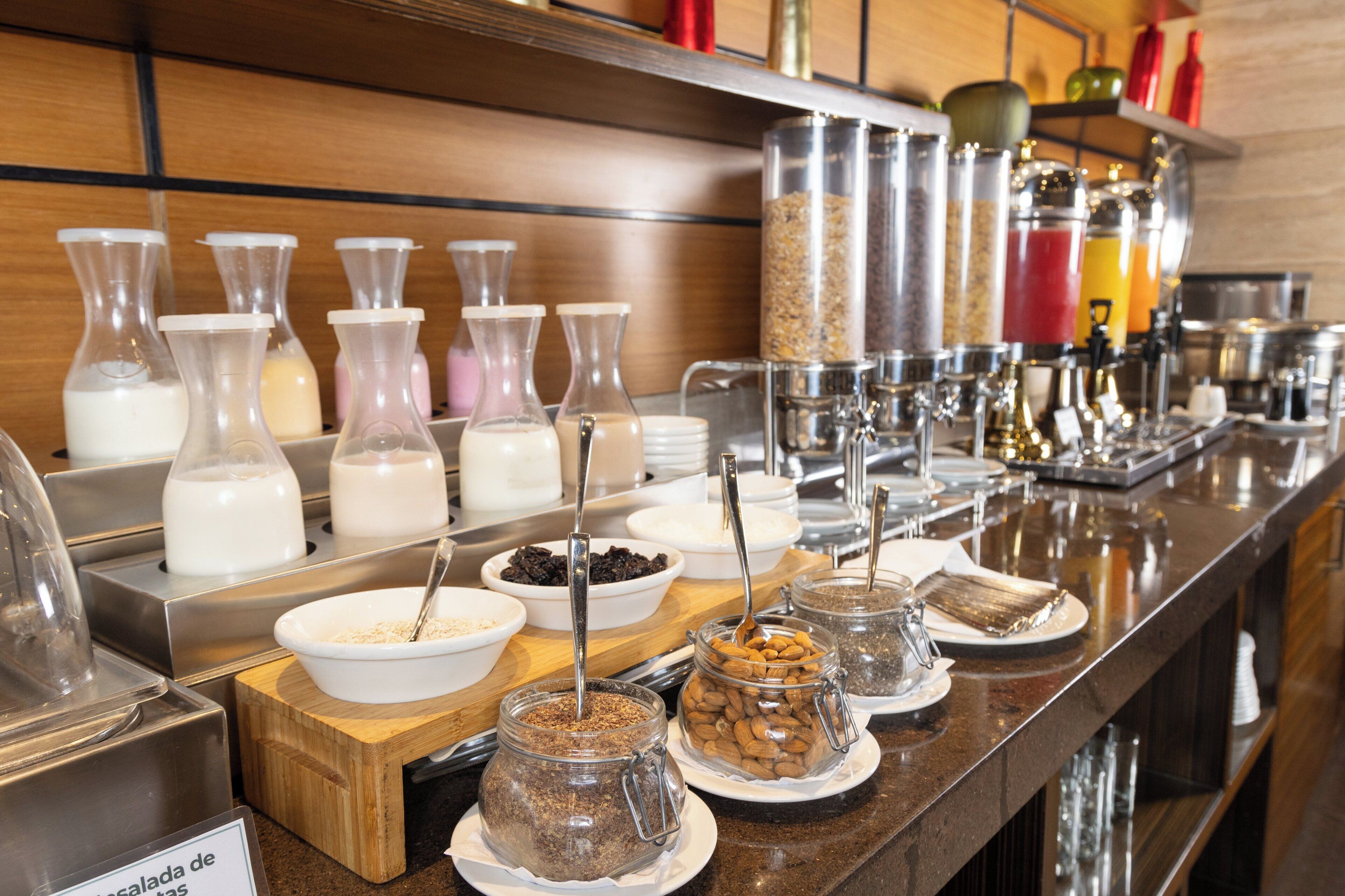 A buffet with various food items and condiments.