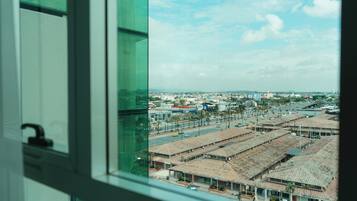 A view of a cityscape through a window with a clear sky.