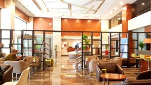 A spacious lobby with a reception desk, seating areas, and a staircase leading to upper floors. - Holiday Inn Gaziantep - Sehitkamil by IHG (Gaziantep)