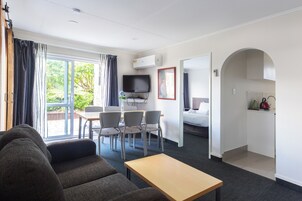 Premium Apartment | Living area | 32-inch flat-screen TV with satellite channels, TV, toys