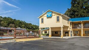 A two-story motel with a sign reading "Rodeway Inn." - Days Inn by Wyndham Calhoun GA I-75 and US-41 (Calhoun)